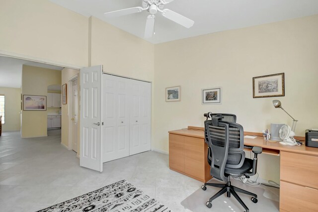 office with baseboards, a ceiling fan, and light tile patterned flooring