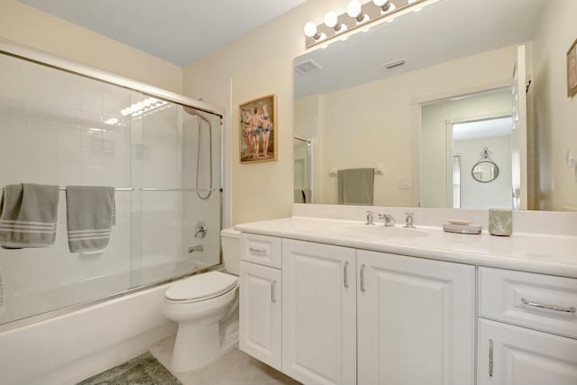 bathroom with visible vents, toilet, enclosed tub / shower combo, vanity, and tile patterned floors