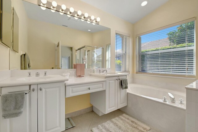 bedroom featuring ceiling fan, a spacious closet, multiple windows, and light tile patterned flooring