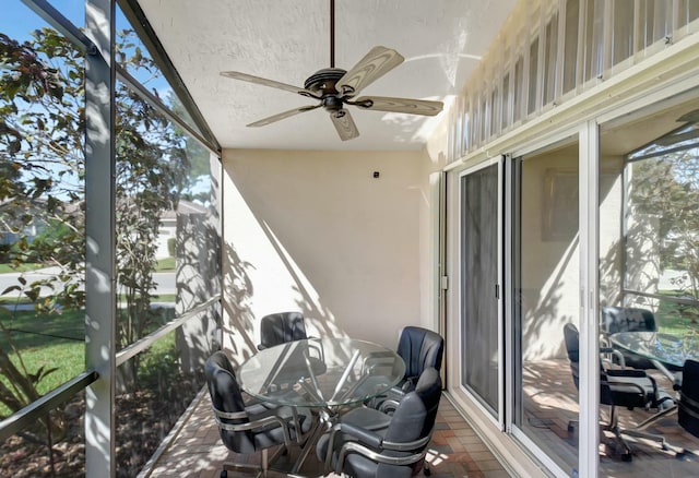 sunroom featuring ceiling fan