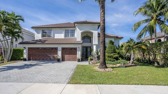 21741 Westmont Ct, Boca Raton, FL 33428 - mediterranean / spanish house featuring a tiled roof, decorative driveway, a front yard, and stucco siding