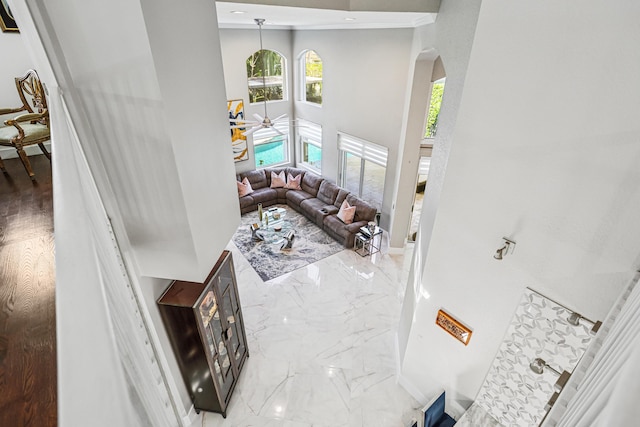 21741 Westmont Ct, Boca Raton, FL 33428 - living room with arched walkways, a towering ceiling, and marble tiled flooring