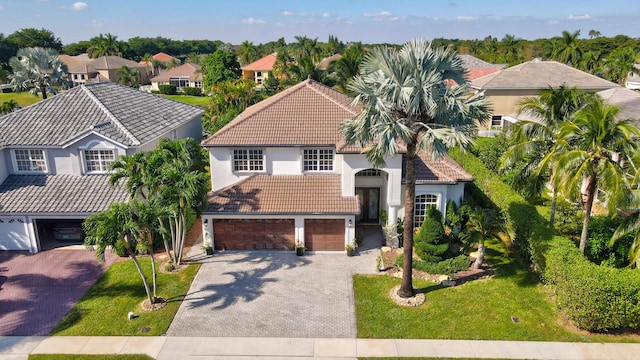 21741 Westmont Ct, Boca Raton, FL 33428 - view of front of property with a tiled roof, a garage, stucco siding, driveway, and a front lawn
