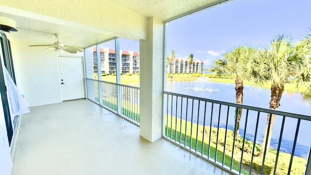 balcony featuring a water view and ceiling fan