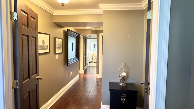 hall with baseboards, ornamental molding, and dark wood-type flooring