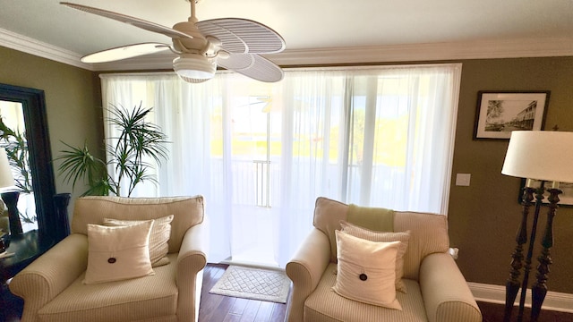 sitting room featuring crown molding, a ceiling fan, and wood finished floors