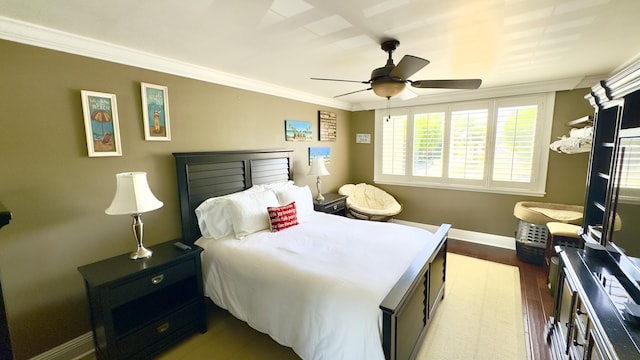 bedroom featuring baseboards, ornamental molding, ceiling fan, and dark wood-style floors