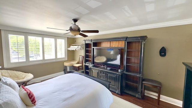 bedroom featuring baseboards, ornamental molding, a ceiling fan, and wood finished floors