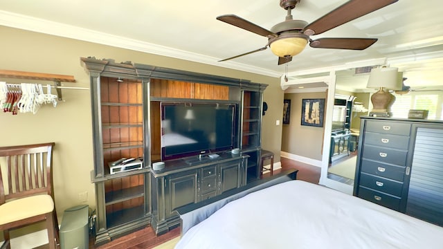 bedroom with baseboards, ornamental molding, wood finished floors, and visible vents