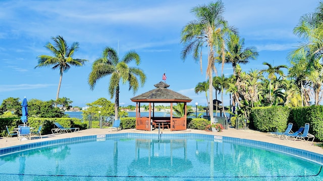 pool featuring fence, a patio, and a gazebo