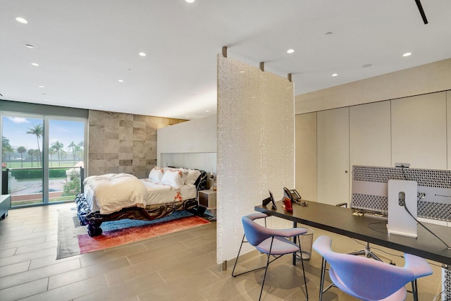 bedroom with access to outside, tile walls, and recessed lighting