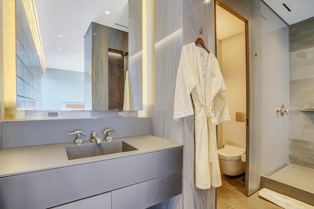 bathroom featuring recessed lighting, vanity, toilet, and tile patterned floors