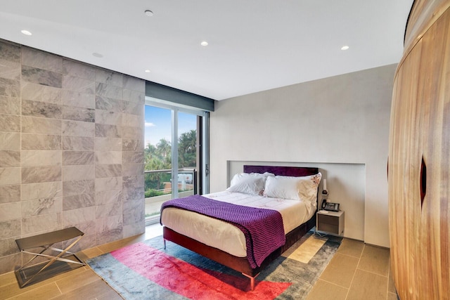 bedroom with access to outside, tile walls, and recessed lighting