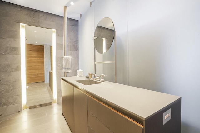 bathroom with vanity, tile walls, and tile patterned floors