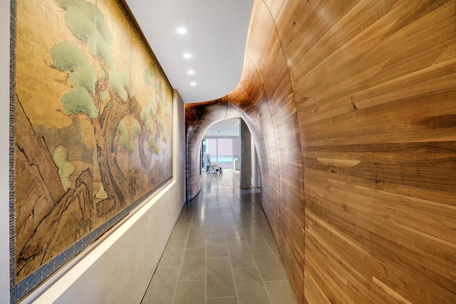 hall featuring recessed lighting, arched walkways, and tile patterned floors