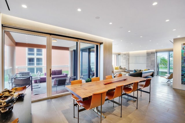 dining room with a wall of windows and recessed lighting