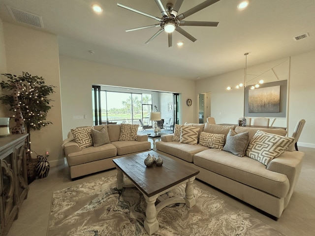 living area with recessed lighting, visible vents, baseboards, and ceiling fan with notable chandelier