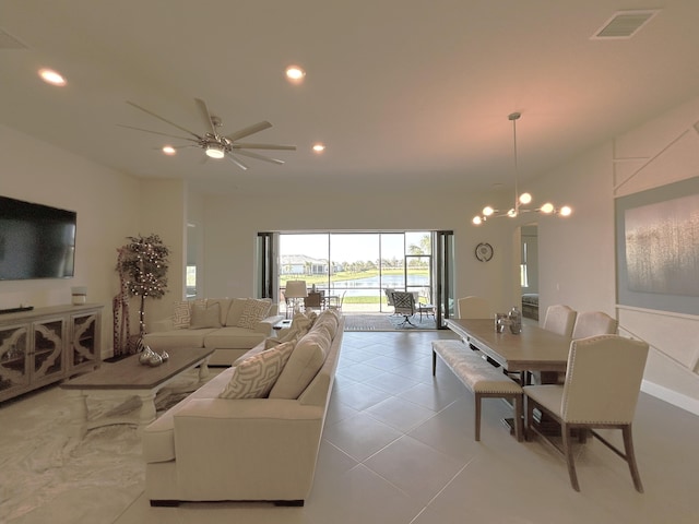 living room featuring visible vents, ceiling fan with notable chandelier, light tile patterned flooring, and recessed lighting