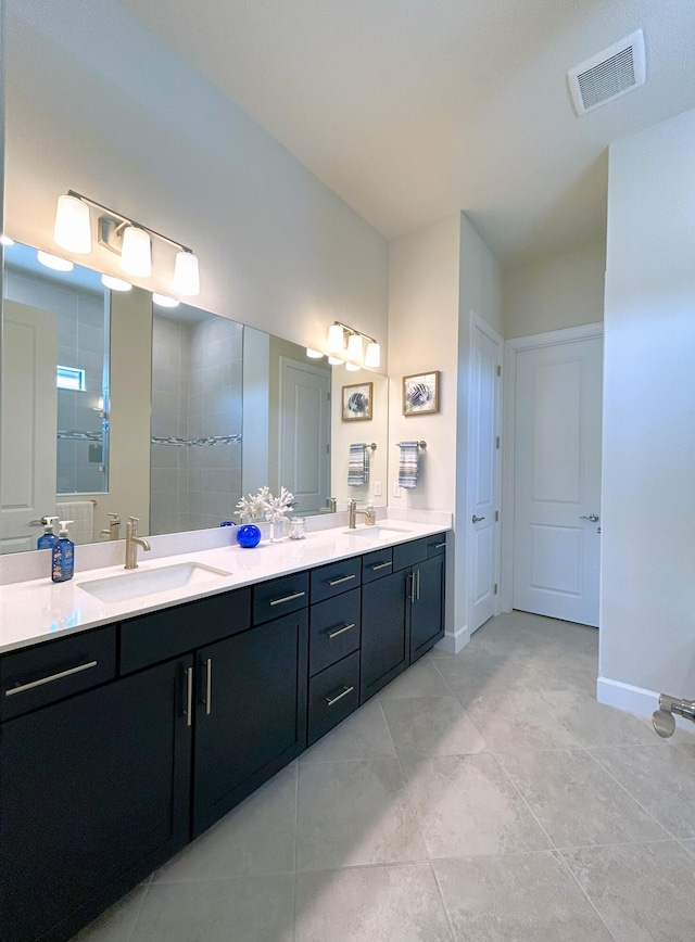 full bathroom featuring double vanity, a sink, visible vents, and baseboards