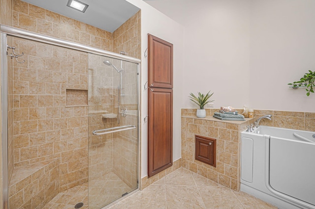 bathroom with a stall shower, tile patterned flooring, and a garden tub