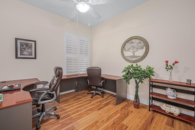 home office featuring baseboards and wood finished floors