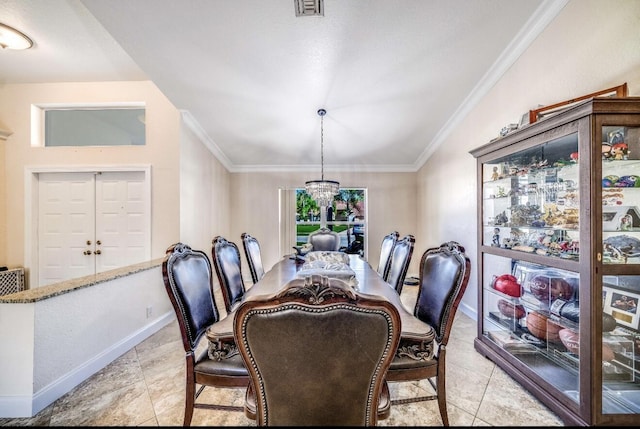 dining room featuring baseboards, ornamental molding, visible vents, and a notable chandelier