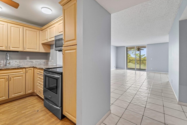 5700 NW 2nd Ave Unit 401, Boca Raton, FL 33487 - kitchen with a sink, a ceiling fan, open floor plan, appliances with stainless steel finishes, and light brown cabinetry