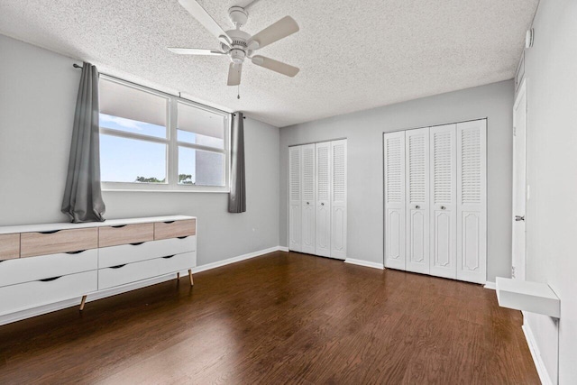 5700 NW 2nd Ave Unit 401, Boca Raton, FL 33487 - unfurnished bedroom with baseboards, a ceiling fan, wood finished floors, a textured ceiling, and multiple closets