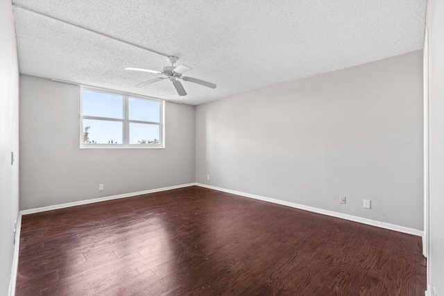 5700 NW 2nd Ave Unit 401, Boca Raton, FL 33487 - spare room with a textured ceiling, dark wood-style flooring, a ceiling fan, and baseboards