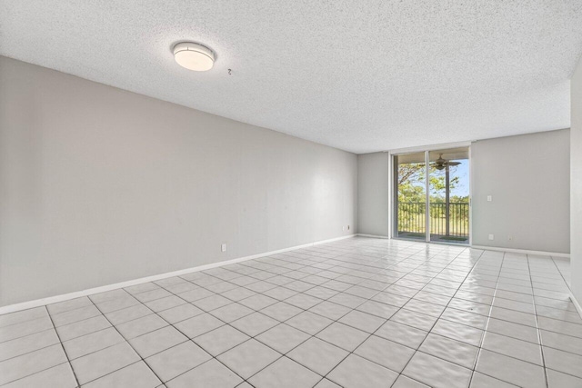 5700 NW 2nd Ave Unit 401, Boca Raton, FL 33487 - empty room featuring expansive windows, light tile patterned flooring, ceiling fan, a textured ceiling, and baseboards