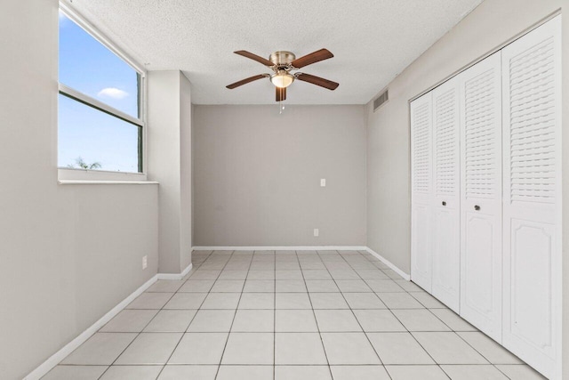 5700 NW 2nd Ave Unit 401, Boca Raton, FL 33487 - unfurnished bedroom featuring a closet, visible vents, ceiling fan, a textured ceiling, and baseboards