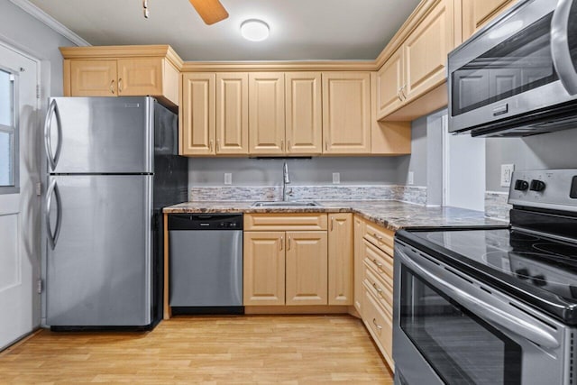 5700 NW 2nd Ave Unit 401, Boca Raton, FL 33487 - kitchen with light stone counters, appliances with stainless steel finishes, light wood-style floors, light brown cabinets, and a sink