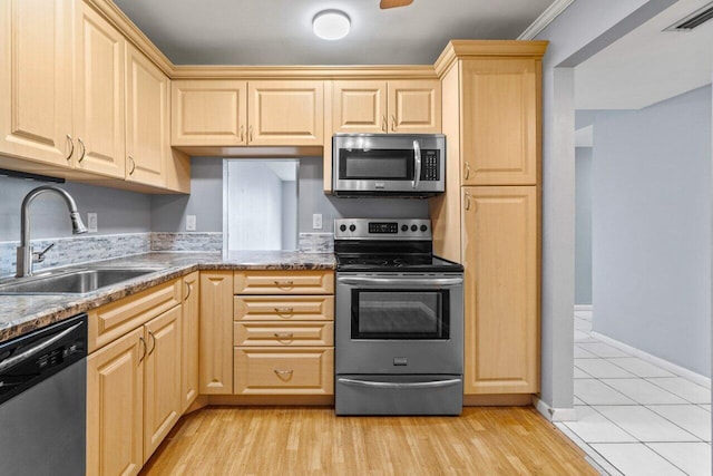 5700 NW 2nd Ave Unit 401, Boca Raton, FL 33487 - kitchen with stainless steel appliances, visible vents, light brown cabinetry, light wood-style floors, and a sink