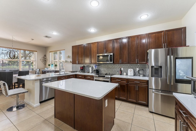 kitchen with visible vents, backsplash, appliances with stainless steel finishes, and light countertops