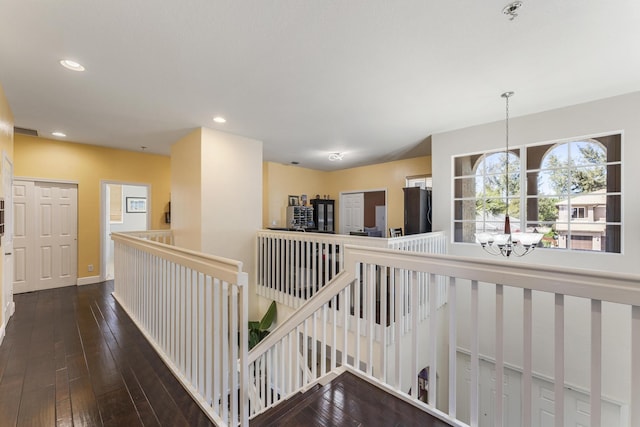 hall featuring visible vents, an upstairs landing, hardwood / wood-style floors, recessed lighting, and a chandelier