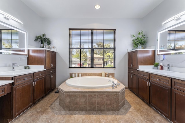 bathroom with a bath, plenty of natural light, and a sink