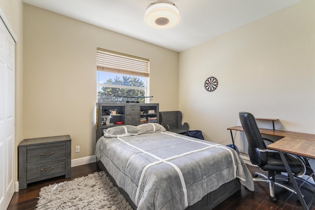 bedroom with wood finished floors and baseboards