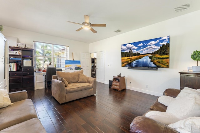 living area with ceiling fan, visible vents, baseboards, and hardwood / wood-style floors