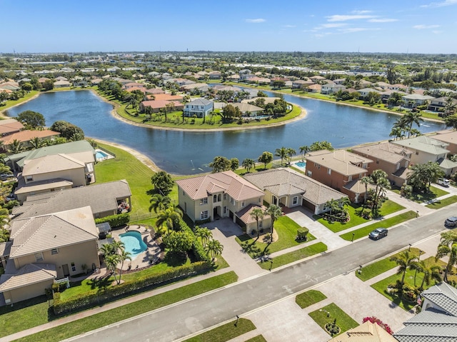 drone / aerial view with a residential view and a water view