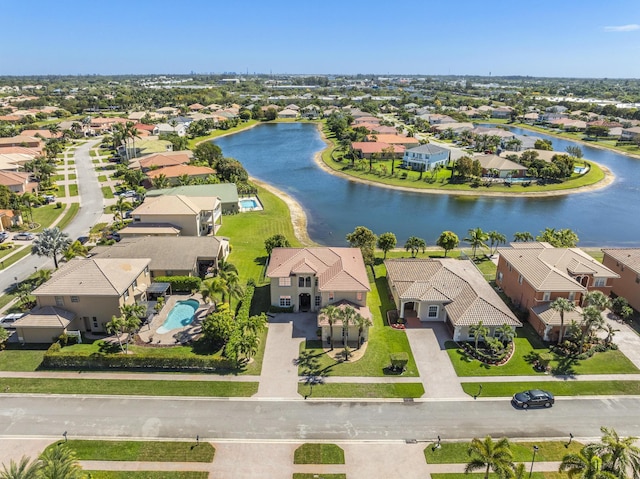 drone / aerial view featuring a residential view and a water view