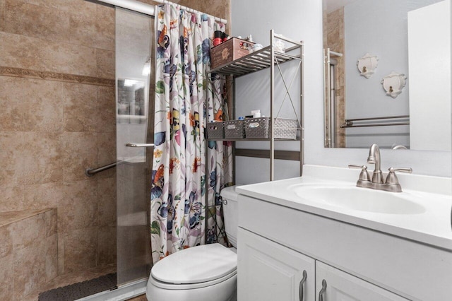 full bathroom with a stall shower, vanity, and toilet