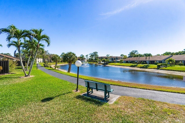 view of community featuring a yard, a water view, and a residential view