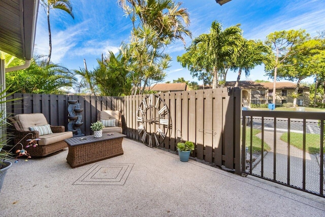 view of patio featuring fence and a gate