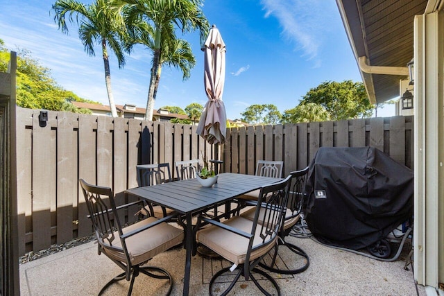 view of patio / terrace featuring outdoor dining area, a grill, and fence