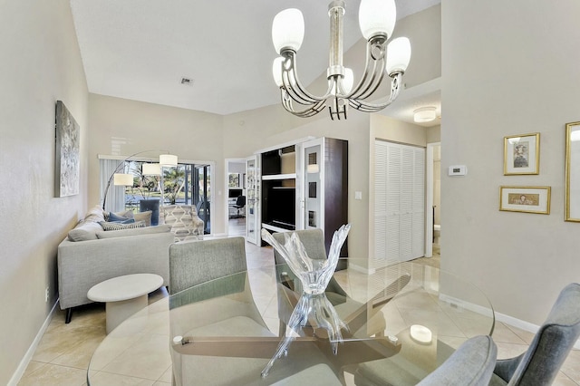 dining area with baseboards, tile patterned flooring, visible vents, and an inviting chandelier