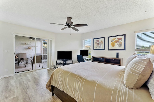 bedroom featuring a textured ceiling, access to outside, ceiling fan, and wood finished floors