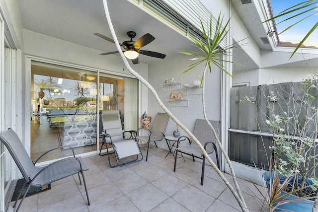 view of patio with a ceiling fan and a lanai