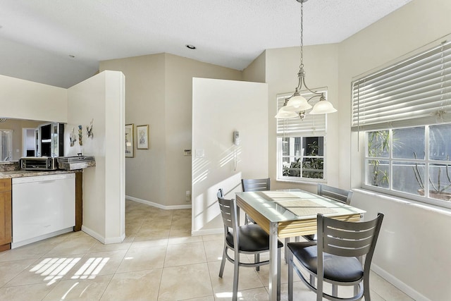 dining room featuring light tile patterned floors, baseboards, and vaulted ceiling