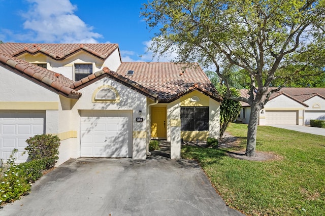 view of front of house with a garage, stucco siding, a tile roof, and a front yard