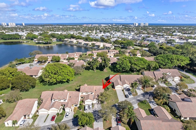 drone / aerial view with a water view and a residential view